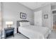 Bright bedroom with gray walls and a large window view at 11325 Juglans Dr, Odessa, FL 33556