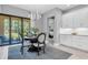 A dining area features a table with four chairs, sliding glass doors, and views of the backyard at 11325 Juglans Dr, Odessa, FL 33556