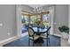 A bright dining area with a round table, four chairs, large sliding glass doors, and an outdoor patio view at 11325 Juglans Dr, Odessa, FL 33556