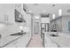 The kitchen features an island, stainless steel appliances, white cabinets, and access to other parts of the home at 11325 Juglans Dr, Odessa, FL 33556