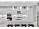 Bright kitchen features white cabinets, an island with seating, stainless steel appliances, and modern pendant lighting at 11325 Juglans Dr, Odessa, FL 33556