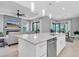 Open-concept kitchen features a granite island, stainless steel appliances, and an adjacent living area at 11325 Juglans Dr, Odessa, FL 33556