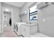Bright laundry room with white cabinets and stainless steel appliances at 11325 Juglans Dr, Odessa, FL 33556