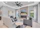 Cozy living room with a fireplace, mounted TV, and comfortable seating, perfect for relaxation at 11325 Juglans Dr, Odessa, FL 33556
