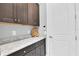Mudroom with dark wood cabinets and light granite counter tops at 11325 Juglans Dr, Odessa, FL 33556