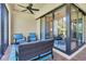 Comfortable patio furniture with a view of the home's interior through sliding glass doors and a view of the outdoors at 11325 Juglans Dr, Odessa, FL 33556