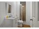 Bathroom with a white vanity and a framed mirror, and a tile shower at 12116 Lamont Dr, Spring Hill, FL 34608