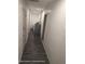 Hallway leading to laundry room, and featuring freshly painted walls and wood look flooring at 12116 Lamont Dr, Spring Hill, FL 34608
