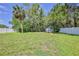 Spacious backyard with mature trees and white privacy fence at 12191 Monarco Ln, Spring Hill, FL 34609