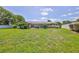 Large backyard has plenty of space for outdoor activities and features a pool at 12191 Monarco Ln, Spring Hill, FL 34609