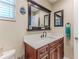 Bathroom vanity with a white countertop, dark wood cabinets, and decorative beach theme at 12191 Monarco Ln, Spring Hill, FL 34609