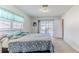 Bright bedroom features a sliding door, providing access to a screened-in pool area at 12191 Monarco Ln, Spring Hill, FL 34609
