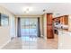 Dining area with tile flooring and sliding glass doors to the backyard pool, adjacent to a kitchen at 12191 Monarco Ln, Spring Hill, FL 34609