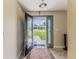 Welcoming foyer with tiled floors and decorative glass front door at 12191 Monarco Ln, Spring Hill, FL 34609