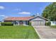 Charming single-story home with well-maintained landscaping and a two-car garage at 12191 Monarco Ln, Spring Hill, FL 34609