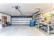 Spacious garage features an automatic door, storage shelves and a functional workbench area at 12191 Monarco Ln, Spring Hill, FL 34609