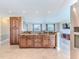 Spacious kitchen bar with beautiful cabinetry and a view to an airy living room and large windows at 12191 Monarco Ln, Spring Hill, FL 34609