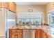 This kitchen showcases granite countertops, stainless steel appliances, and a window view of lush greenery at 12191 Monarco Ln, Spring Hill, FL 34609