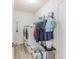 Convenient laundry room featuring a stackable washer and dryer with storage at 12191 Monarco Ln, Spring Hill, FL 34609