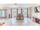 Comfortable living room with tile floors, plenty of natural light, and neutral-toned walls at 12191 Monarco Ln, Spring Hill, FL 34609