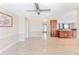 Living room showcases smooth flooring, natural light, with a partial view of the kitchen area at 12191 Monarco Ln, Spring Hill, FL 34609