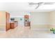 A well-lit living area boasts smooth tile flooring, with views into the kitchen area at 12191 Monarco Ln, Spring Hill, FL 34609