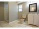 A bathroom featuring a vanity, toilet with wood seat, and a tiled shower in the corner at 12210 Quail Run Row, Hudson, FL 34667