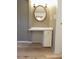 Bathroom with vanity, storage, wood-look floors, decorative mirror, and an entry to a closet at 12210 Quail Run Row, Hudson, FL 34667