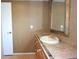 A bathroom featuring a vanity with an oval sink, decorative tile and a framed mirror at 12210 Quail Run Row, Hudson, FL 34667