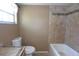 A bathroom showcasing beige tiled walls surrounding a tub with a neutral accent tile at 12210 Quail Run Row, Hudson, FL 34667