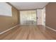 Bedroom with wood-look floors, large windows, and a sliding glass door leading to the porch at 12210 Quail Run Row, Hudson, FL 34667
