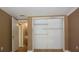 Bedroom with open closet and sliding doors and an open door to another room at 12210 Quail Run Row, Hudson, FL 34667