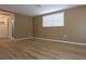 Bedroom with light-colored walls, wood-look floors, large windows, and access to a walk-in closet at 12210 Quail Run Row, Hudson, FL 34667