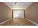 Bedroom with wood-look flooring and a large window to bring in natural light at 12210 Quail Run Row, Hudson, FL 34667