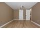 An empty bedroom boasting wood-look flooring and access to another room at 12210 Quail Run Row, Hudson, FL 34667
