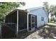 A view of the covered back porch with a screened door and fence at 12210 Quail Run Row, Hudson, FL 34667