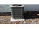 Exterior view of a gray air conditioner unit sitting on a concrete platform at 12210 Quail Run Row, Hudson, FL 34667