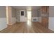 Cozy living room with neutral walls, wood-look flooring, and access to a kitchen area and a back door at 12210 Quail Run Row, Hudson, FL 34667
