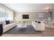 Stylishly furnished living room with plush white sofas, a sleek coffee table, and modern decor at 12210 Quail Run Row, Hudson, FL 34667
