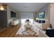 Nicely decorated living room featuring wood floors, white sofas, and modern furniture with dark-blue cushions at 12210 Quail Run Row, Hudson, FL 34667