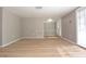 Bright and airy living room with light-colored walls, trim, and laminate flooring and a front-door view at 12210 Quail Run Row, Hudson, FL 34667