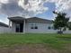 Well-maintained backyard with healthy grass, covered patio, and shade tree at 12630 Aston Dr, Hudson, FL 34669