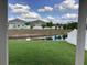 Inviting backyard with lush green grass and serene pond view with white fencing at 12630 Aston Dr, Hudson, FL 34669