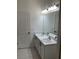 Bathroom featuring double vanity with marble countertop, modern lighting, and tiled flooring at 12630 Aston Dr, Hudson, FL 34669
