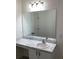Bright bathroom features marble countertop, sink, vanity, with a large mirror and modern lighting at 12630 Aston Dr, Hudson, FL 34669