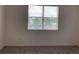 Bedroom with neutral carpeting, blinds, and neutral walls, creating a calm, inviting space at 12630 Aston Dr, Hudson, FL 34669