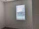 An empty bedroom features neutral walls, carpet flooring, and a window with blinds at 12630 Aston Dr, Hudson, FL 34669