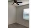 An empty bedroom features neutral walls, carpet flooring, a window with blinds, and ceiling fan at 12630 Aston Dr, Hudson, FL 34669