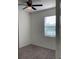 An empty bedroom features neutral walls, carpet flooring, a window with blinds, and ceiling fan at 12630 Aston Dr, Hudson, FL 34669