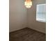 An empty bedroom features neutral walls, carpet flooring, a window with blinds, and modern ceiling light at 12630 Aston Dr, Hudson, FL 34669